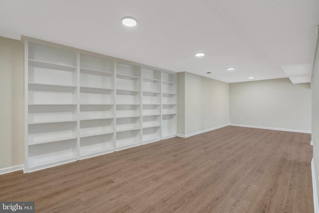 finished basement with recessed lighting, wood finished floors, and baseboards