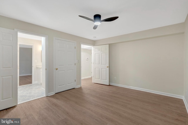 unfurnished bedroom with ceiling fan, baseboards, and wood finished floors