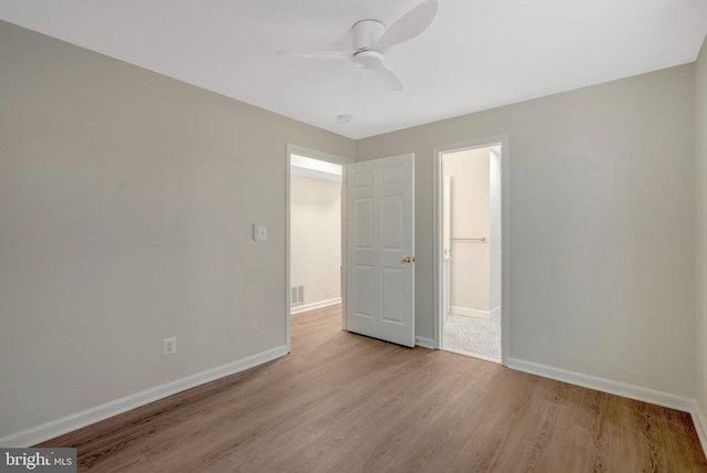 unfurnished bedroom featuring visible vents, light wood finished floors, a ceiling fan, and baseboards