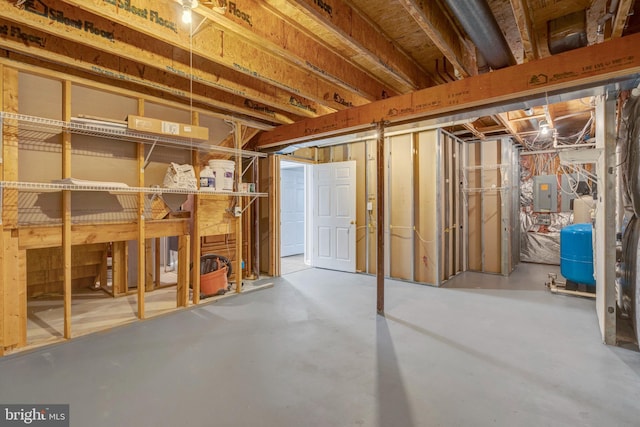 unfinished basement featuring electric panel