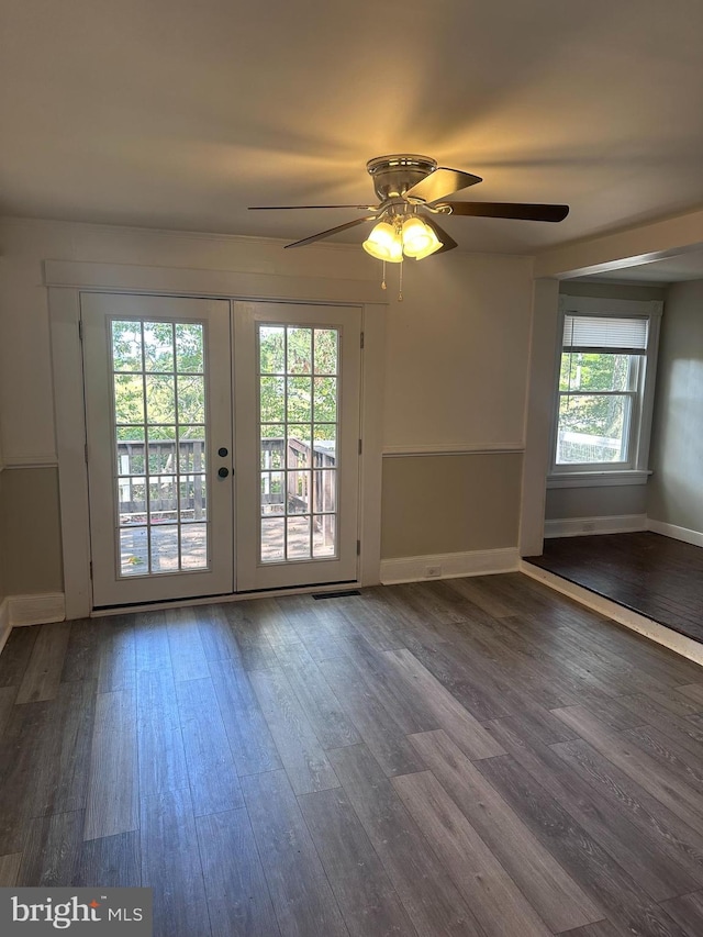 interior space with ceiling fan, baseboards, wood finished floors, and french doors