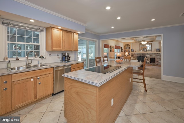 kitchen featuring a sink, stainless steel dishwasher, a brick fireplace, black electric cooktop, and a center island