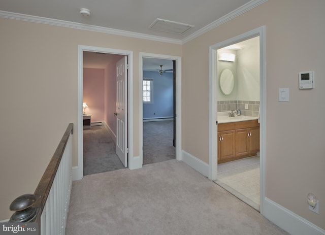 hallway featuring visible vents, light carpet, an upstairs landing, a sink, and a baseboard radiator