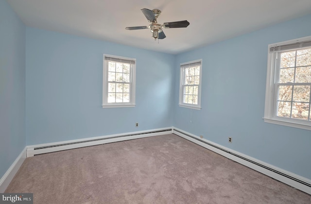 empty room with a baseboard radiator, carpet floors, and a ceiling fan