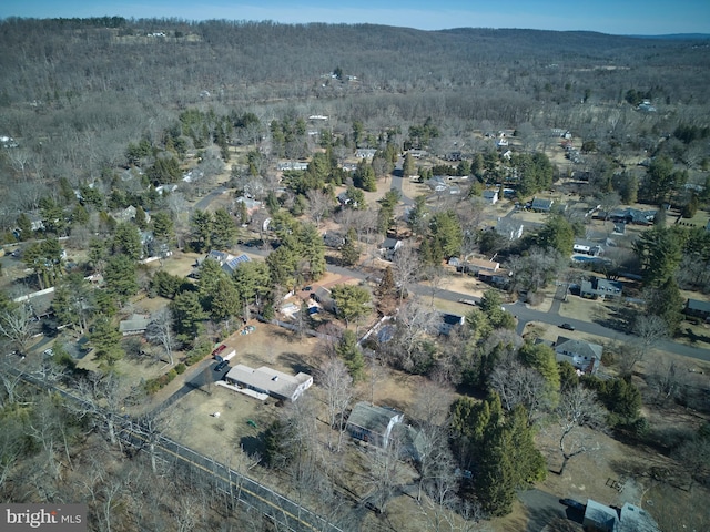 birds eye view of property with a wooded view