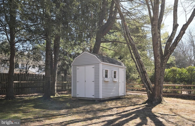 view of shed featuring fence