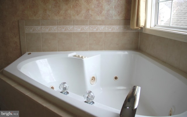 full bath with a jetted tub and wallpapered walls