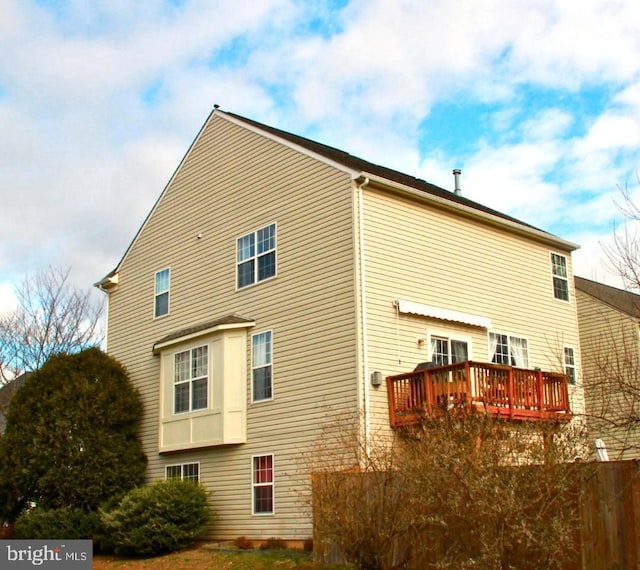 view of property exterior with a deck