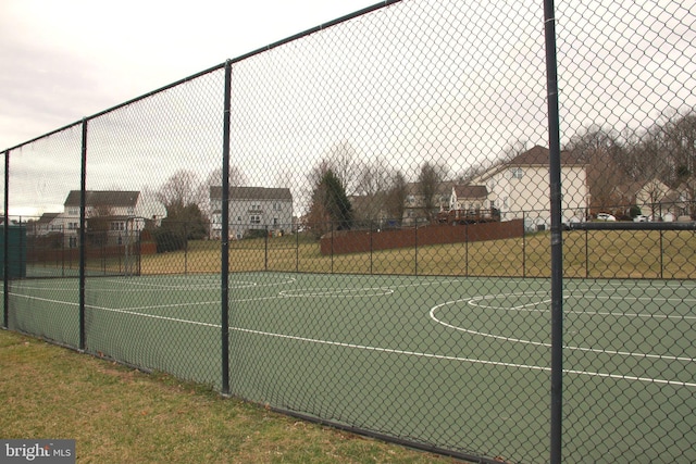 view of basketball court with community basketball court and fence