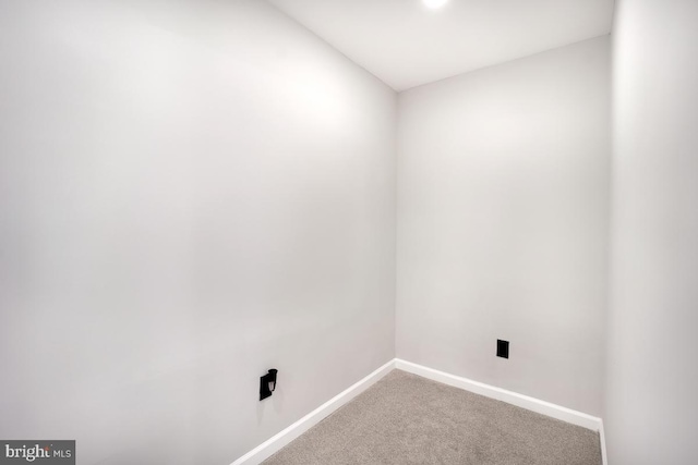 laundry room with carpet and baseboards