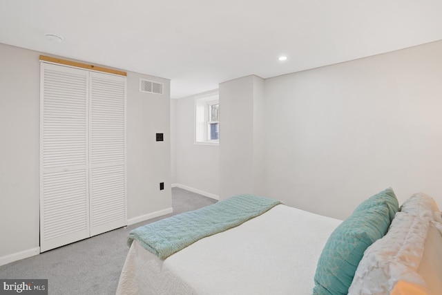 bedroom featuring carpet, a closet, visible vents, and baseboards