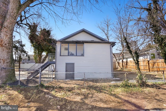 back of property featuring fence private yard and stairway