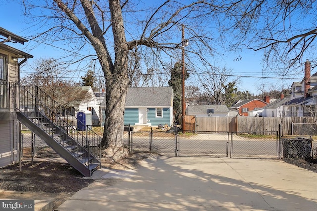 view of yard with stairway, a residential view, and a gate