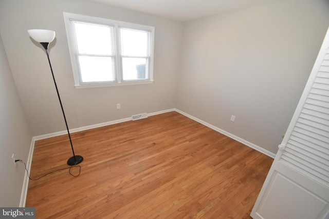 unfurnished bedroom featuring baseboards, visible vents, and light wood-style floors