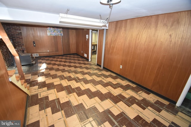 interior space featuring wooden walls and tile patterned floors