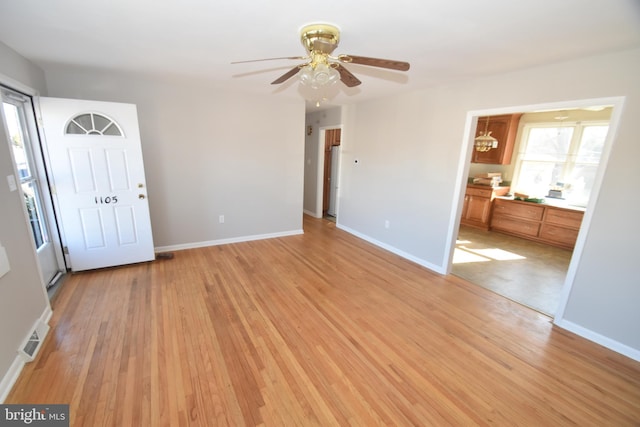 interior space with light wood-type flooring, plenty of natural light, and baseboards