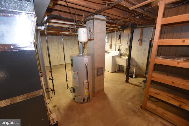 unfinished basement with water heater and washer and clothes dryer