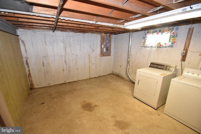 unfinished below grade area with washer and clothes dryer and electric panel