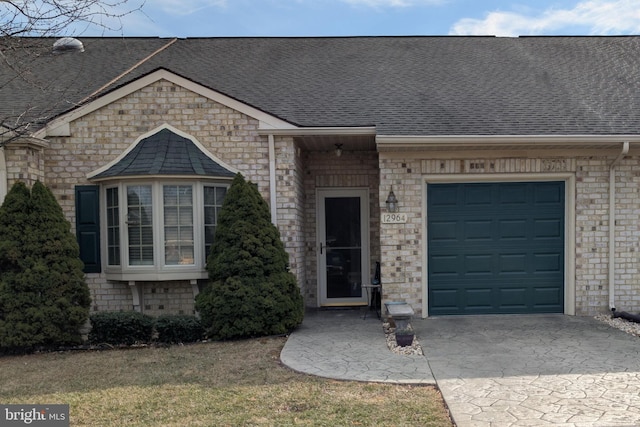 view of front of property with a garage, brick siding, and a shingled roof