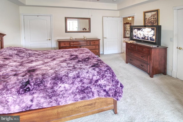 bedroom with light colored carpet