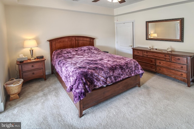 bedroom with a ceiling fan and light colored carpet