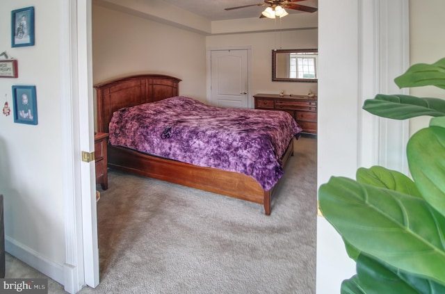 carpeted bedroom with ceiling fan