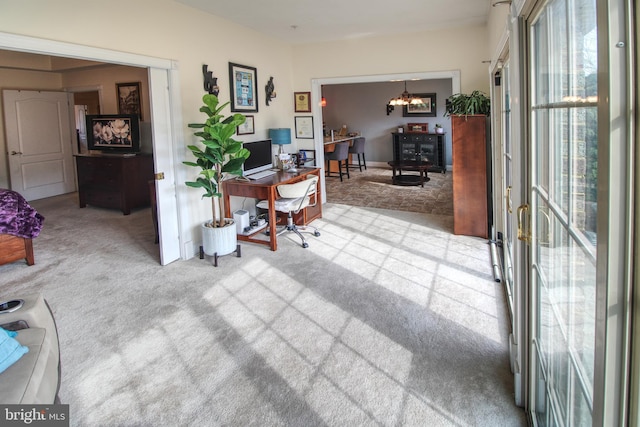 home office featuring a healthy amount of sunlight and carpet flooring