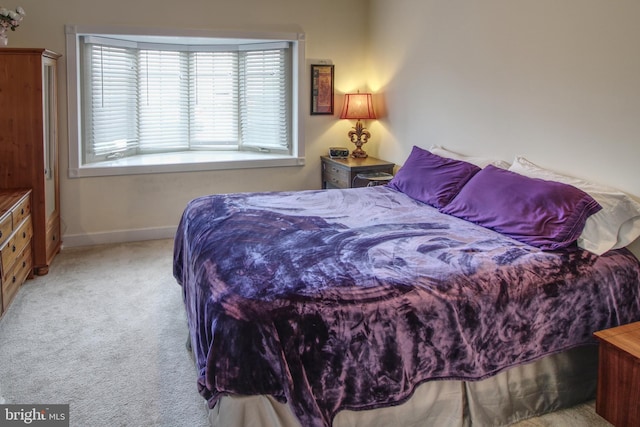 bedroom featuring carpet floors and baseboards