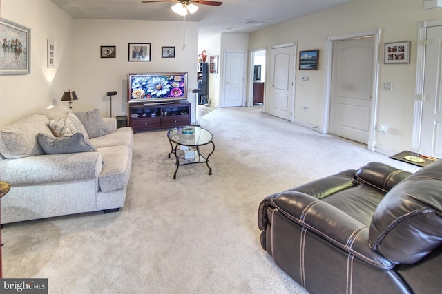 carpeted living area with a ceiling fan, visible vents, and baseboards