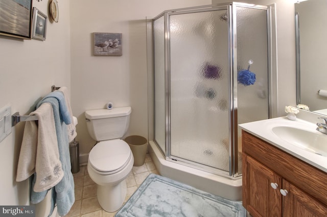 bathroom with toilet, tile patterned flooring, a shower stall, and vanity