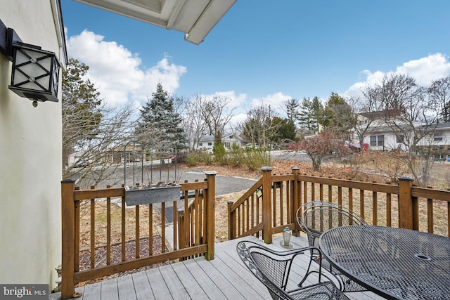 wooden terrace featuring outdoor dining area