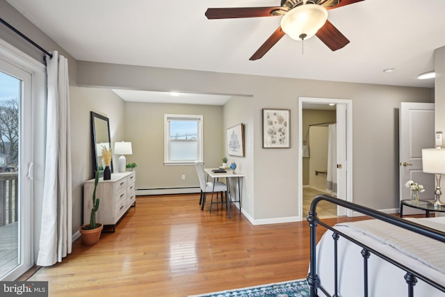 bedroom featuring light wood finished floors, a baseboard radiator, access to exterior, and baseboards