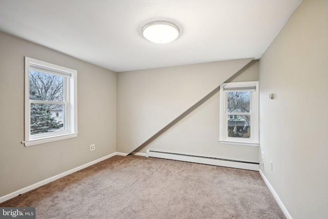 unfurnished room with carpet floors, baseboards, and baseboard heating