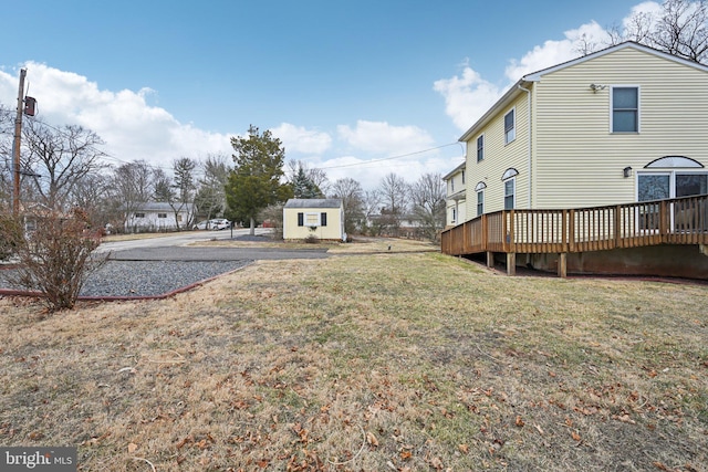 view of yard with an outbuilding and a wooden deck