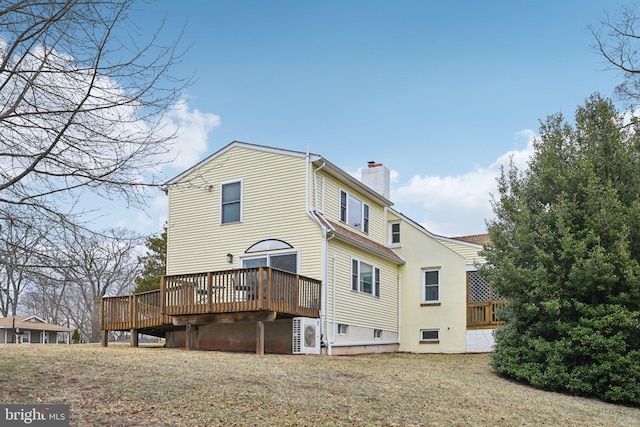 rear view of house featuring ac unit, a chimney, and a wooden deck