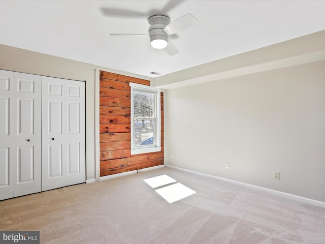 unfurnished bedroom featuring baseboards, carpet floors, and a closet