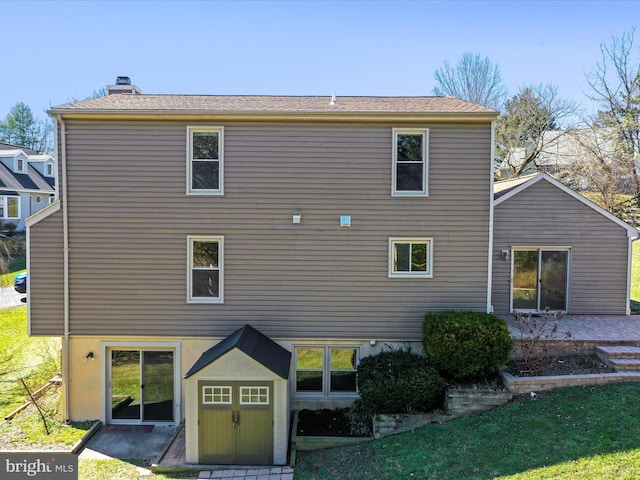 back of property with a patio area and a chimney