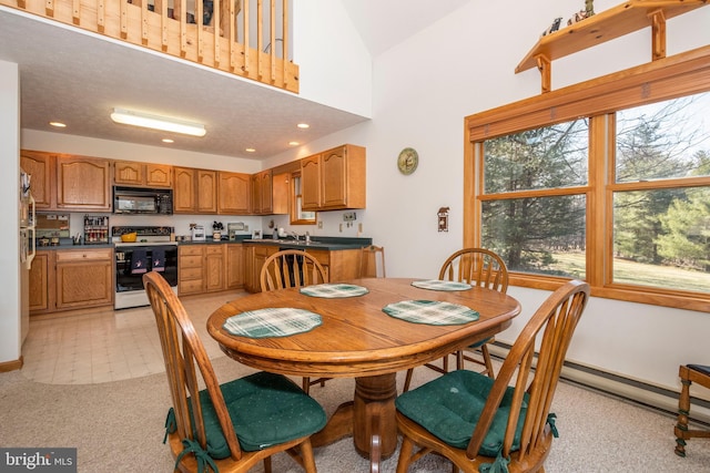 dining area with recessed lighting, light colored carpet, and a towering ceiling