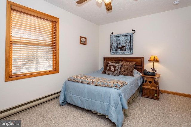 bedroom featuring carpet floors, baseboards, a baseboard heating unit, and a ceiling fan