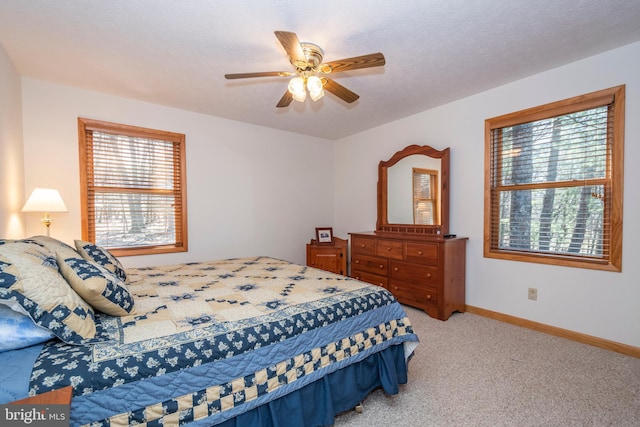 bedroom with a textured ceiling, ceiling fan, carpet, and baseboards