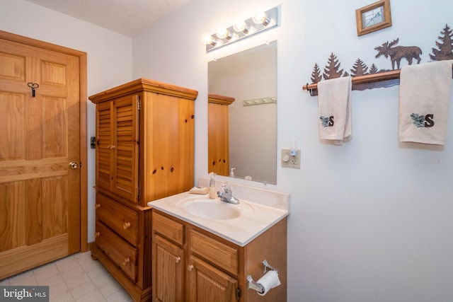 bathroom with tile patterned floors and vanity