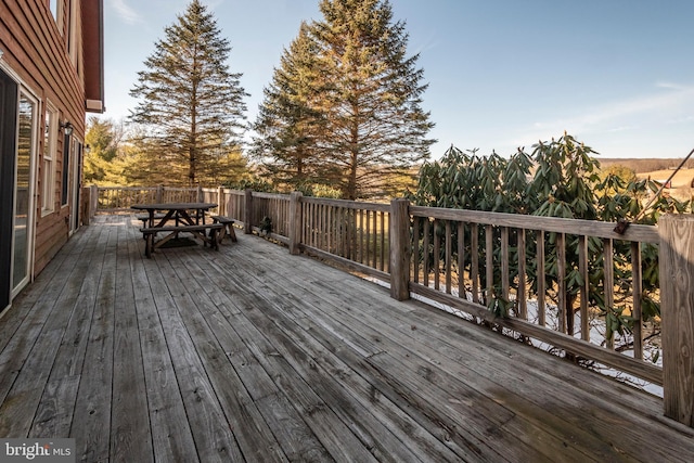 wooden deck featuring outdoor dining area