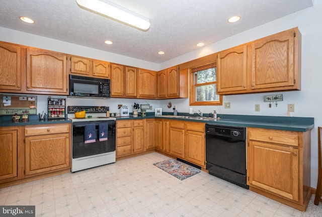 kitchen featuring light floors, dark countertops, brown cabinets, and black appliances