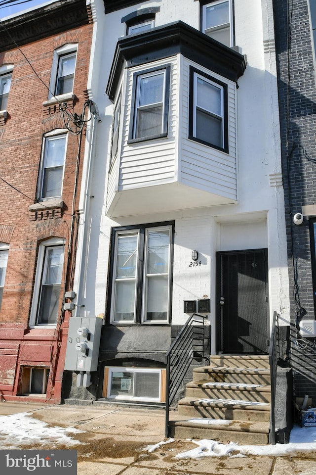 view of property featuring brick siding