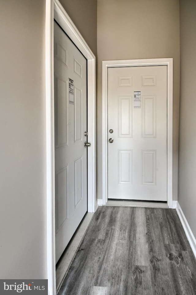 interior space with baseboards and wood finished floors