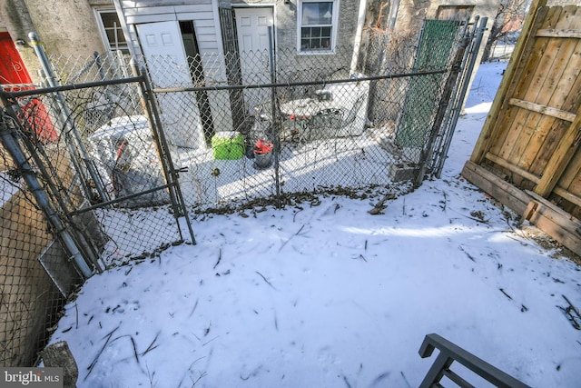 snow covered gate featuring fence