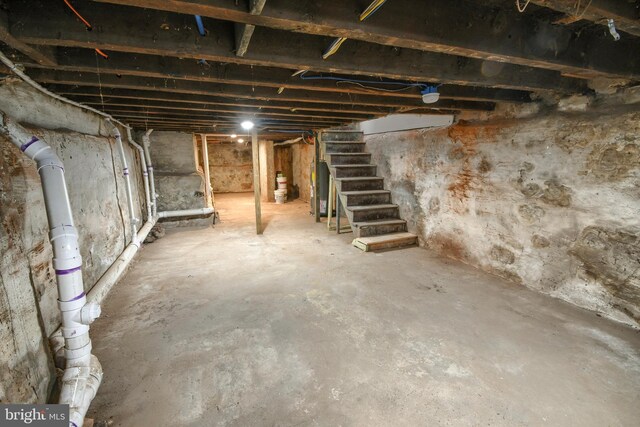 unfinished below grade area with water heater and stairway