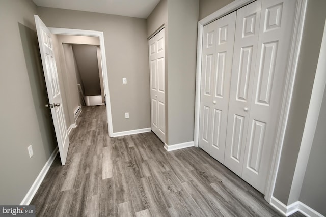 unfurnished bedroom featuring baseboards and wood finished floors