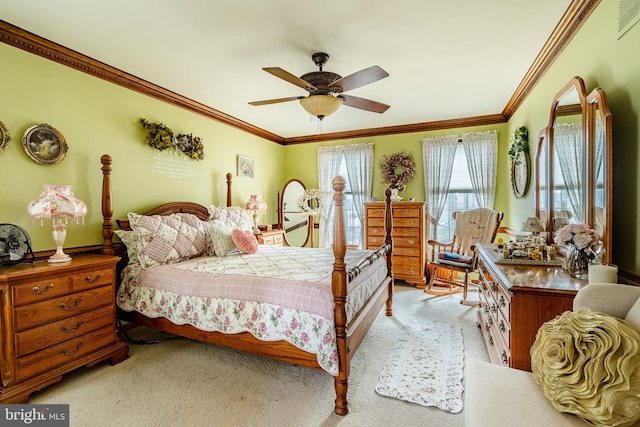 carpeted bedroom featuring a ceiling fan and crown molding