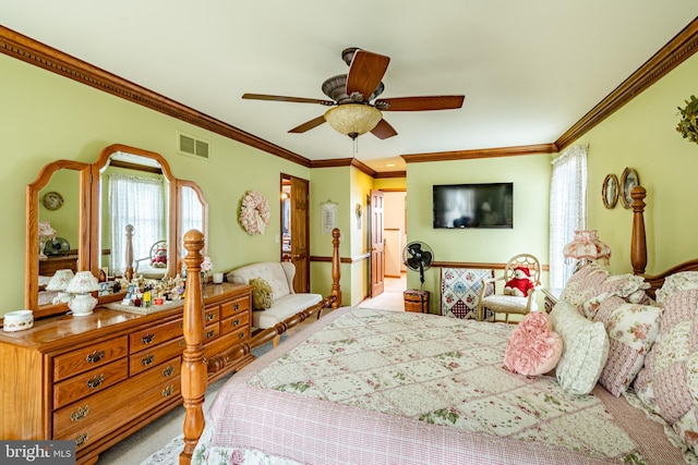 carpeted bedroom with ornamental molding, multiple windows, visible vents, and a ceiling fan